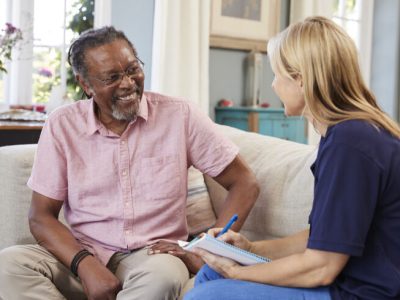 Female Support Worker Visits Senior Man At Home